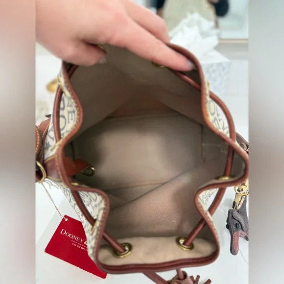 Dooney & Bourke Ivory and Brown Bucket Bag with Dachshund Leather Charm